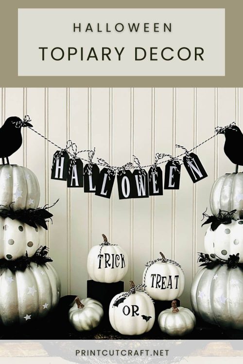 Halloween topiary with pumpkins, crows, and banner.